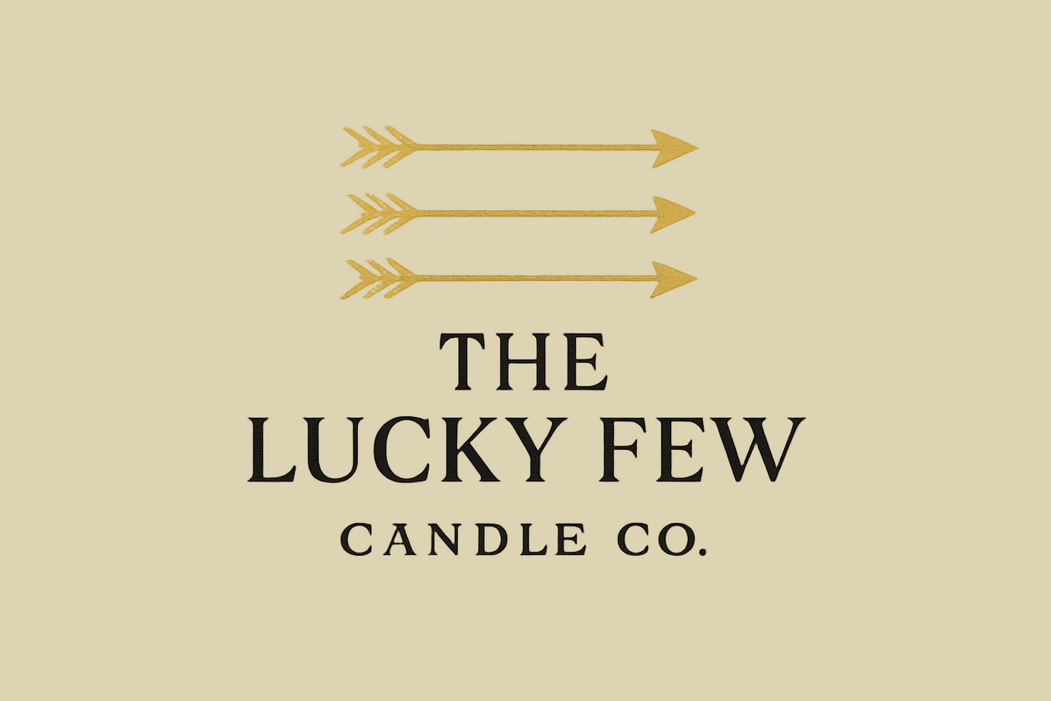THE LUCKY FEW CANDLE CO. WORDS WITH THREE GOLD HORIZONTAL ARROWS ABOVE, MODERN AND BEAUTIFUL 